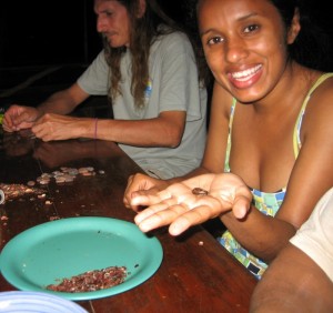 Marlyn Cruz (Front) and Jacob Marlin (back) taking the shell off of roasted cacao beans. 